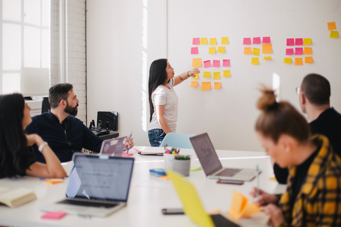 Strategy session with performance metrics on whiteboard